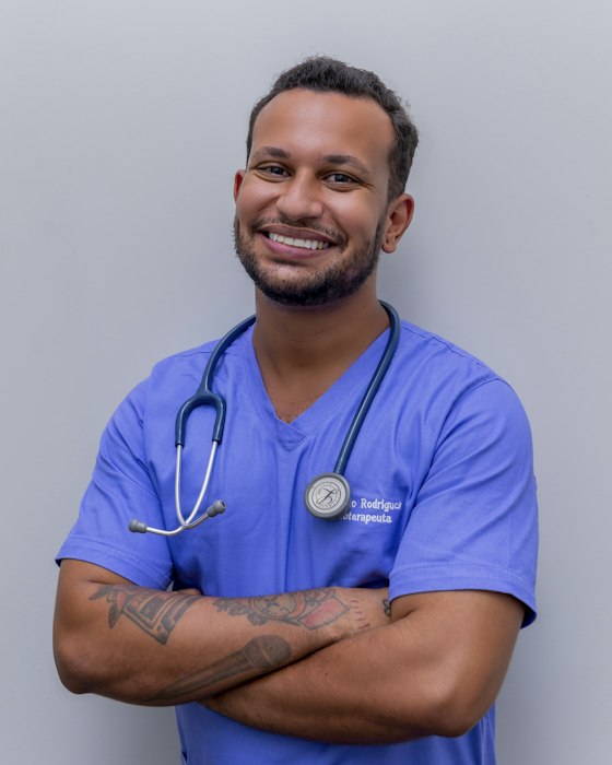 A clinician in blue scrubs with a stethoscope